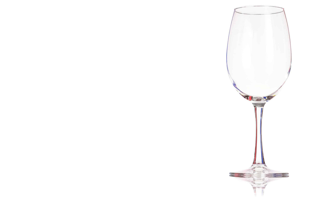 An empty glass of red wine or water isolated on a white background. Place for your text.