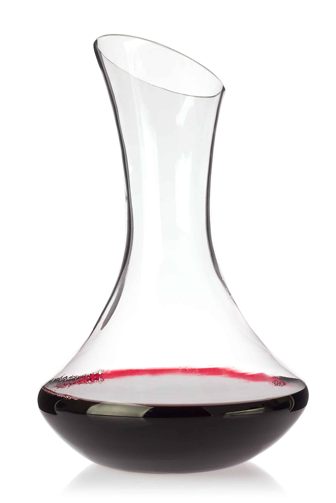 Glass decanter with organic red wine, isolated on white background.